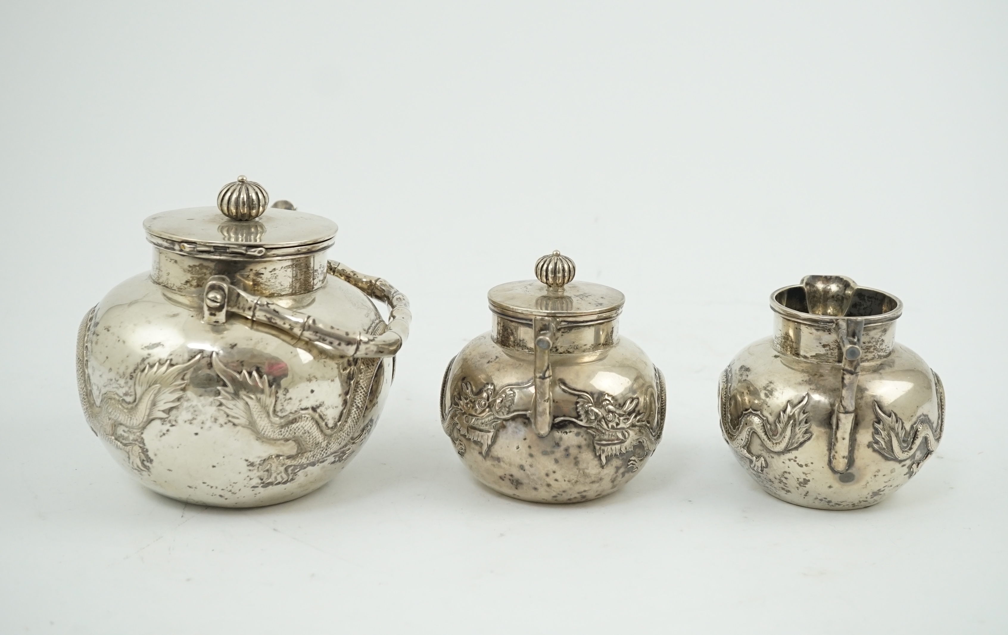 A late 19th/early 20th century Chinese Export silver three piece tea set, by Luen Wo, Shanghai